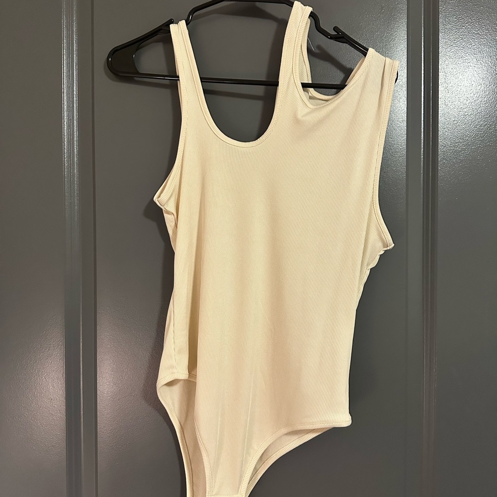 Cream bodysuit with cutout detail #cutoutdetail